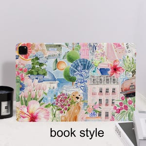 May include: A colorful tablet case with a collage design featuring flowers, buildings, and a dog holding flowers. The case has the words "book style" printed on it. The design includes pink, blue, and orange elements.