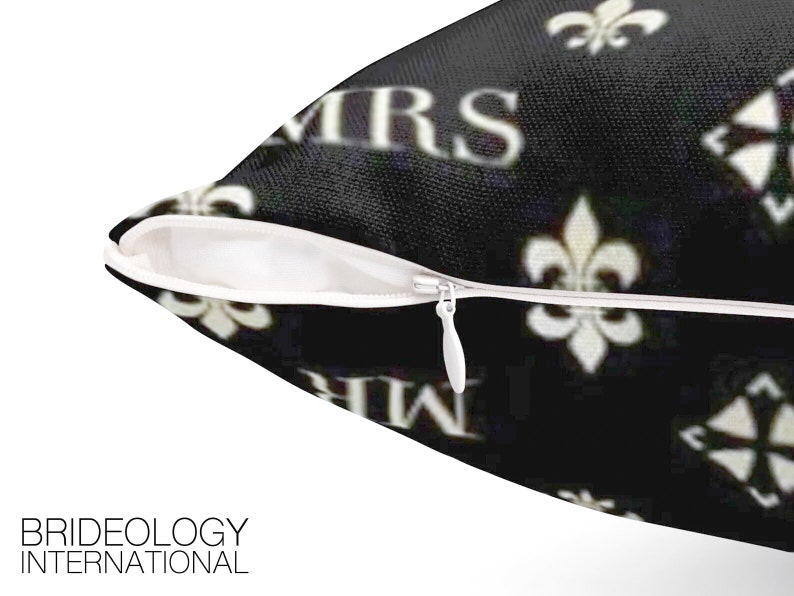 May include: Black and white pillow with a zipper closure. The pillow has a repeating pattern of the words "Mr." and "Mrs." and a fleur-de-lis design.