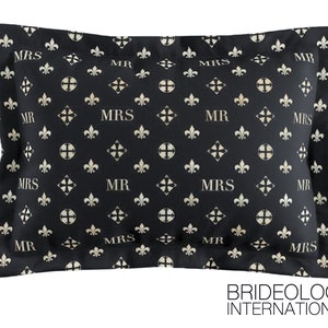 May include: Black pillowcase with a repeating pattern of gold fleur-de-lis and the words "MR" and "MRS".