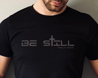 May include: Black t-shirt with the text "BE STILL" and "PSALM 46:10" in gray.