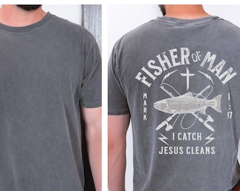 May include: A dark gray t-shirt with a distressed graphic on the back. The graphic features a fish, fishing rods, and the text "Fisher of Man Mark 1:17 I Catch Jesus Cleans".