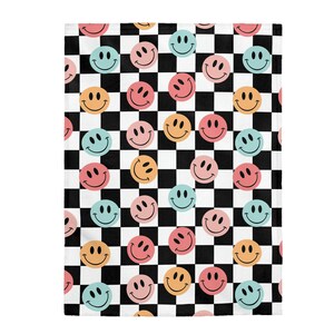 May include: Checkerboard pattern in black and white with a repeating pattern of colorful smiley faces in blue, yellow, pink, and orange.