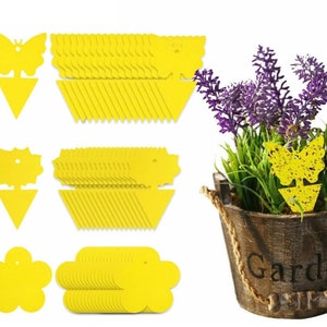 May include: A set of yellow sticky traps for catching flying insects. The traps are shaped like butterflies, flowers, and stars. There are 50 traps in total. The traps are shown next to a potted lavender plant.