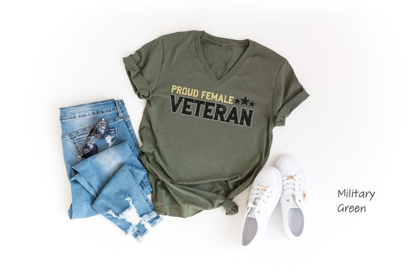 a shirt that says proud female veteran next to a pair of jeans