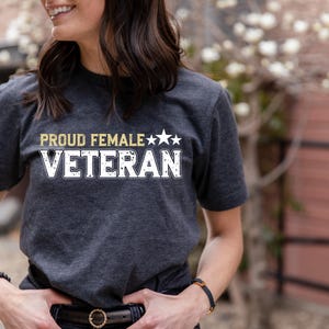 a woman wearing a t - shirt that says proud female veteran