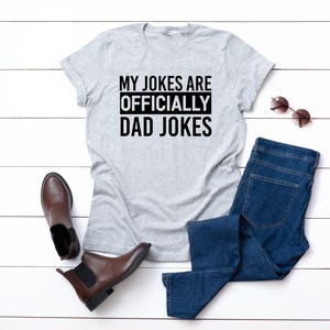 a t - shirt that says, my jokes are officially dad jokes