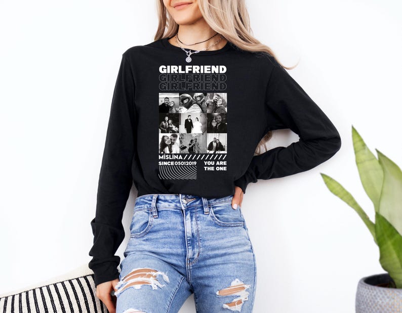 a woman wearing a black shirt and ripped jeans