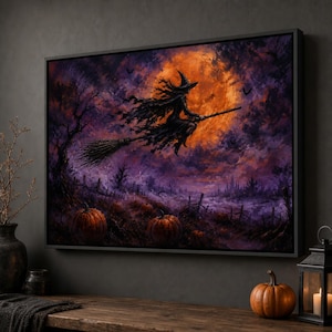 May include: A framed rectangular wall art print depicting a witch flying on a broomstick against a large orange full moon. The scene features a dark purple cloudy sky, silhouettes of bare trees, a wooden fence, and orange pumpkins on the ground.