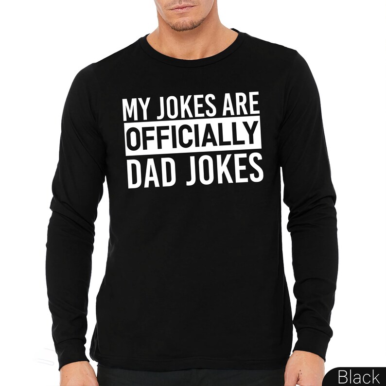 a man wearing a black shirt that says, my jokes are officially dad jokes