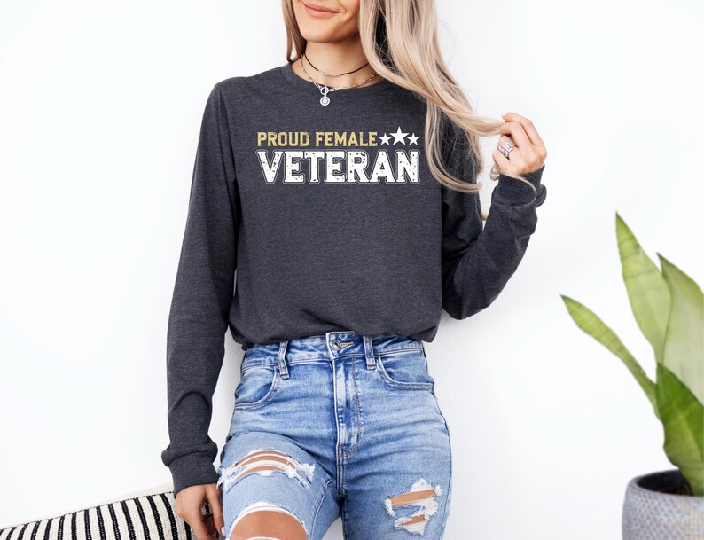 a woman wearing a black sweatshirt and ripped jeans