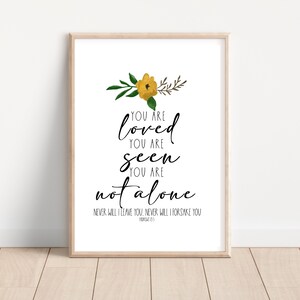 May include: A printable wall art design featuring a yellow flower and green leaves. The text reads "You are loved, You are seen, You are not alone. Never will I leave you, never will I forsake you."