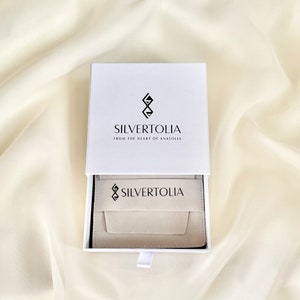Our standard jewelry packaging includes a sponge filled safe drawer box and a suede pouch which you can use to store and clean your jewelry.