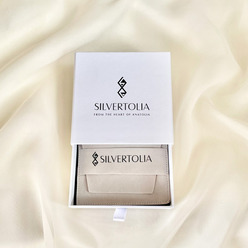 Our standard jewelry packaging includes a sponge filled safe drawer box and a suede pouch which you can use to store and clean your jewelry.