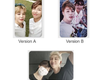 May include: Three different versions of a photo card featuring two men. The first version shows two men in a grassy outdoor setting. The second version shows two men in a boat on the water. The third version shows two men in an indoor setting.