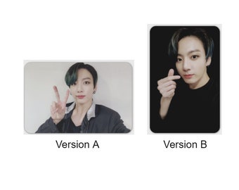 May include: Two photos of a man with green hair. In the first photo, the man is wearing a black jacket and making a peace sign with his fingers. In the second photo, the man is wearing a black shirt and making a heart shape with his fingers.