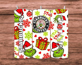 May include: A white Starbucks tumbler featuring Grinch-themed designs. The tumbler includes Grinch faces, snowflakes, gift boxes, and the Starbucks logo. The words "Starbucks" and "Stink Stank Stunk" are also visible.