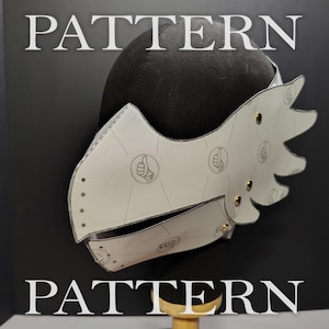 May include: A white helmet template featuring a repeating graphic of a hand giving a thumbs-up gesture. The structure is made of flat, connected panels with visible metallic rivets and a jagged, wing-like extension on the side, displayed on a black form.