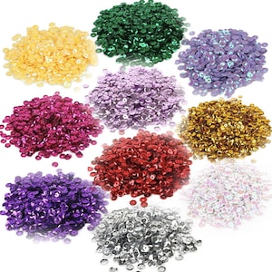 May include: Assortment of 10mm round sequins in various colours, including gold, silver, red, green, purple, and pink. The sequins are arranged in piles on a white background.