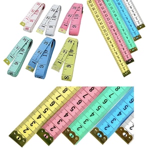 May include: Assortment of colorful measuring tapes with black numbers. The tapes are yellow, pink, light blue, and green. The tapes are all 60 inches long and have a metal end cap.