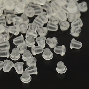 May include: A large quantity of clear plastic earring backs. The backs are small and round with a small hole in the centre.