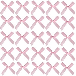 May include: A sheet of 36 pink satin bows. The bows are arranged in a grid pattern.