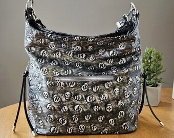 Large Slouchy Shoulder Bag with Embossed Skull pattern, Goth Style Hobo Bag with Side Zip Pockets