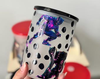 Op de afbeelding: Matte tumbler met Black Panther-illustraties in dynamische poses. De tumbler heeft een zwart deksel en is versierd met zwarte stippen. Het ontwerp toont levendige kleuren en een dynamisch superheldenthema.