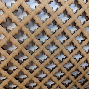 May include: A close-up of a wooden lattice with a repeating pattern of squares and crosses. The lattice is made of thin strips of wood that are joined together to create a grid-like design. The wood is a light brown color and the lattice has a natural, rustic look.