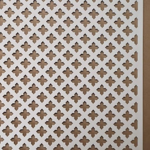 May include: White decorative metal grille with a repeating pattern of four-pointed stars. The grille is made of thin metal and has a slightly textured surface.