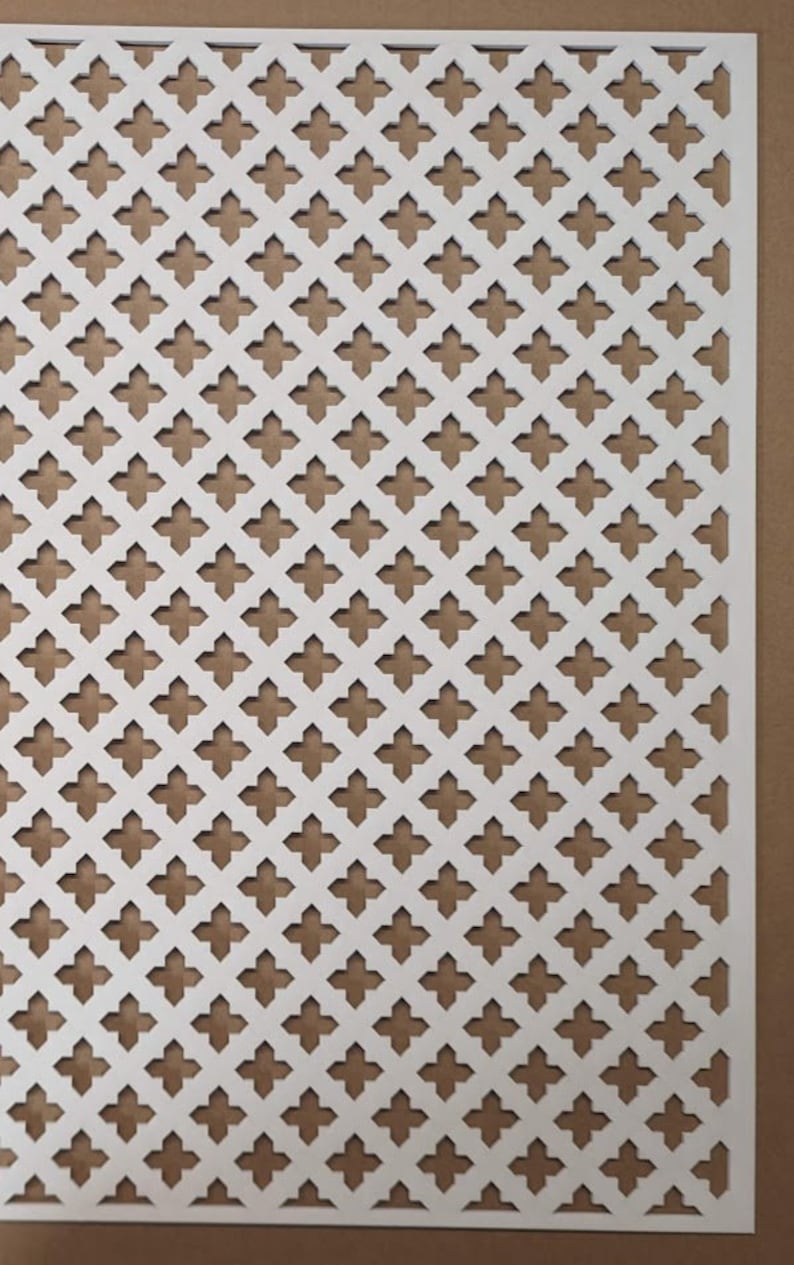 May include: White decorative metal grille with a repeating pattern of four-pointed stars. The grille is made of thin metal and has a slightly textured surface.