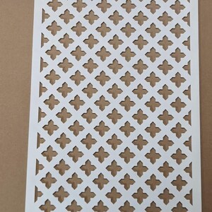 May include: White metal decorative grille with a repeating diamond pattern. The grille is made of thin metal and has a smooth finish.