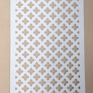 May include: White metal decorative screen with a repeating pattern of small, four-pointed stars. The screen is made of thin metal and has a slightly textured surface.