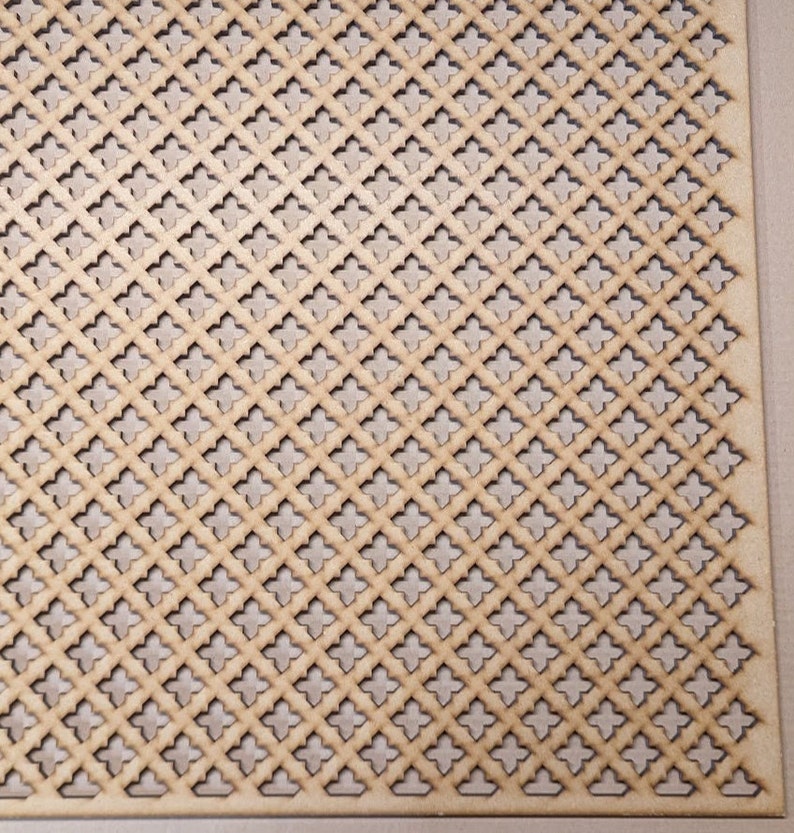 May include: A close-up of a light brown wooden panel with a repeating pattern of diamond-shaped cutouts. The cutouts are arranged in a grid pattern, creating a decorative and airy effect.