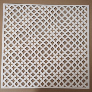May include: White metal decorative grille with a repeating diamond pattern. The grille has a square shape and is made of thin metal.