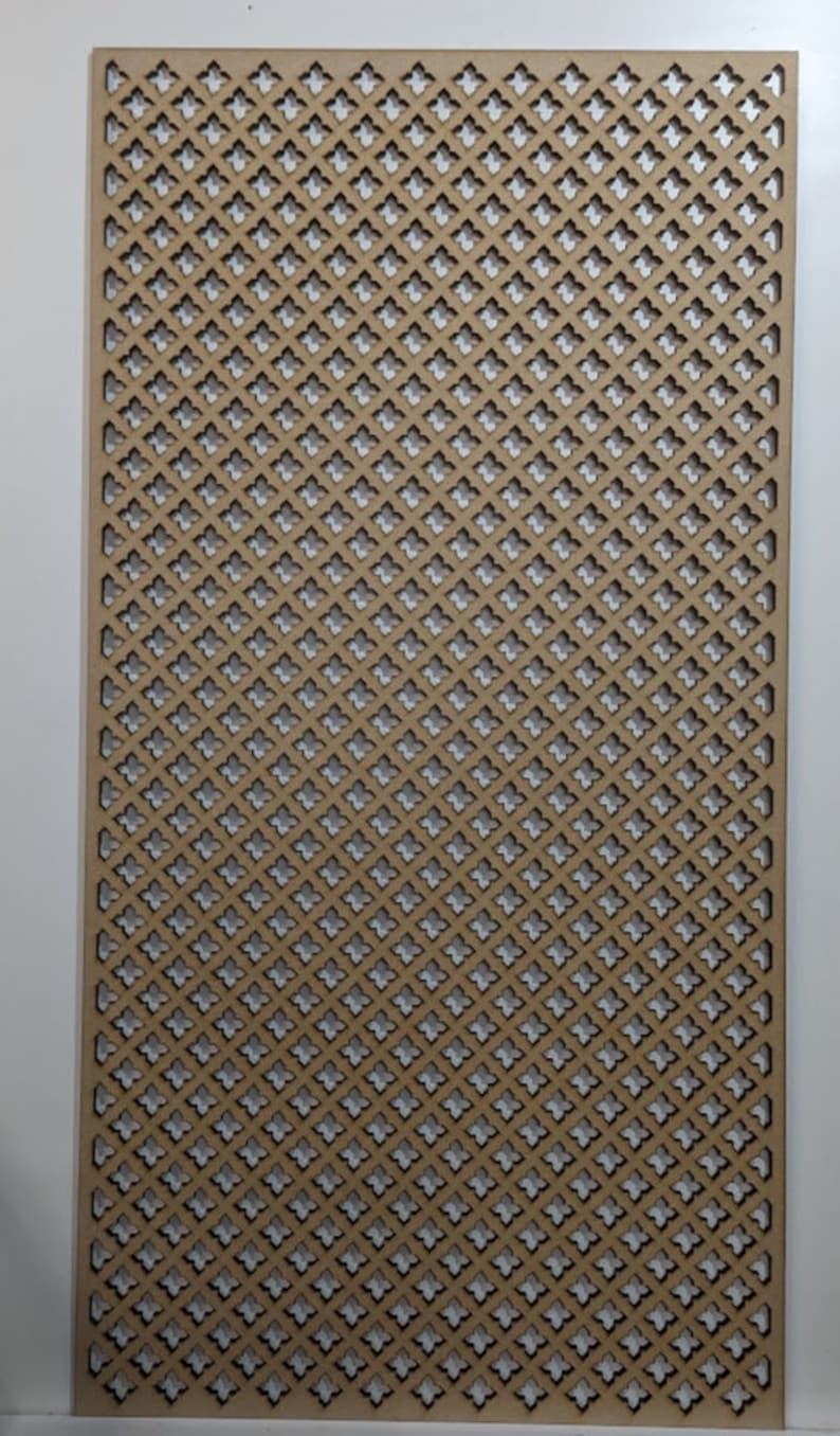May include: A brown wooden lattice panel with a repeating geometric pattern of small, diamond-shaped cutouts. The panel is made of thin wood and has a light brown color.