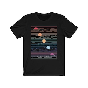 May include: A black t-shirt with a graphic design of a colorful, abstract landscape with mountains, waves, and multiple suns.