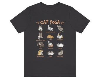 Peut inclure: Un t-shirt noir avec un graphique blanc d'un tableau de yoga pour chats. Le tableau présente différentes poses de yoga avec des chats dans chaque pose. Les poses incluent : Latus, Chat tourné vers le bas, Enfant, Jambes contre le mur, Cadavre, Cobra, Assis en avant et Queue au sommet.