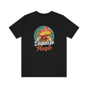 May include: Black t-shirt with a retro-style graphic of a mushroom with the text "Legalize Magic" printed on it.