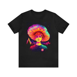 May include: A black t-shirt with a colorful graphic of a person with a mushroom on their head. The mushroom is rainbow colored and has a galaxy pattern inside. The person is wearing a galaxy patterned shirt and has a flower on their chest.