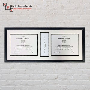 May include: A black framed double matted diploma frame with two diplomas inside. The diplomas are for a Master of Business Administration degree. The text on the diplomas reads "University Diploma".