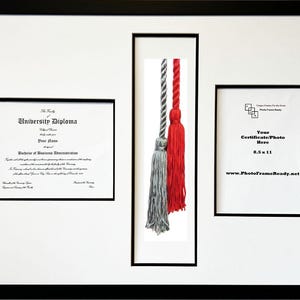 May include: A black diploma frame with a white mat and a black diploma inside. The frame also includes a small photo opening and a separate opening for a graduation tassel. The text on the diploma reads "University Diploma".