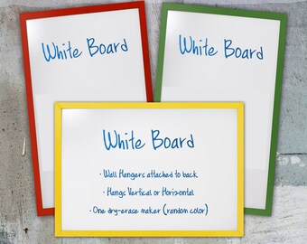 May include: Three whiteboards with yellow, green, and red frames. The whiteboard in the center has the text "White Board" and a list of features: "Wall Hangers attached to back", "Hangs Vertical or Horizontal", and "One dry-erase maker (random color)".