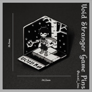 May include: A black and white enamel pin featuring a character holding a staff in a forest setting. The pin measures 36.8mm by 34.2mm and includes the text "VOID" on the base. The design depicts a figure on a platform with a tree and stars.