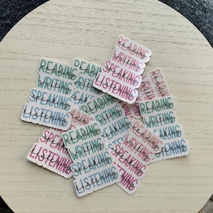 May include: A collection of colorful stickers with the words "Reading", "Writing", "Speaking", and "Listening" repeated on each sticker.