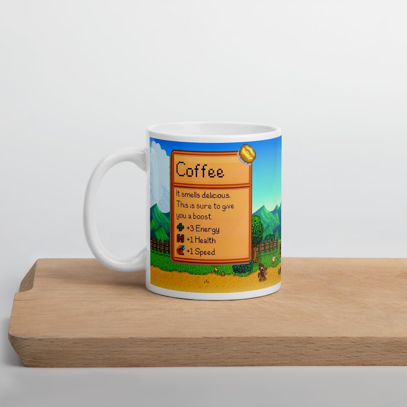 May include: White ceramic mug with a pixelated image of a coffee bean and text that reads "Coffee" and "It smells delicious. This is sure to give you a boost. +3 Energy +1 Health +1 Speed".