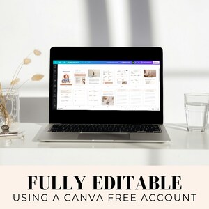 May include: A laptop computer displaying a Canva design template on the screen. The template is a planner with a light blue background and white text. The text on the screen says "Weekly Planner". The laptop is on a white desk with a glass of water and a vase of dried flowers.