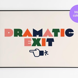 May include: A framed art print featuring the words "DRAMATIC EXIT" in colourful block letters. Below the text is a graphic of a pointing hand and a running figure. A purple circle with "More colours" is in the upper right corner.