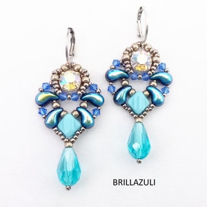 May include: A pair of dangle earrings with a teardrop-shaped crystal pendant. The earrings are made with blue and silver beads and feature a clear crystal in the center.