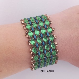 May include: A green and blue beaded bracelet with copper accents. The bracelet is made with small, faceted beads and has a geometric pattern.