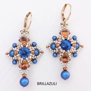 May include: A pair of blue and gold beaded earrings with a cross-shaped design and a blue gemstone in the center. The earrings are hanging from gold hooks.